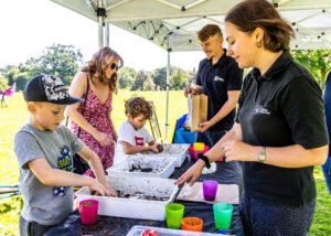 Photograph of people on a stall making seed bombs